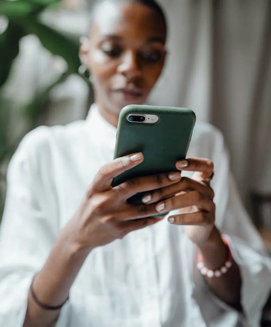 Person holding a smartphone while paying online